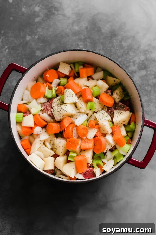 Chopped ingredients for Irish stew in a large pot before cooking.