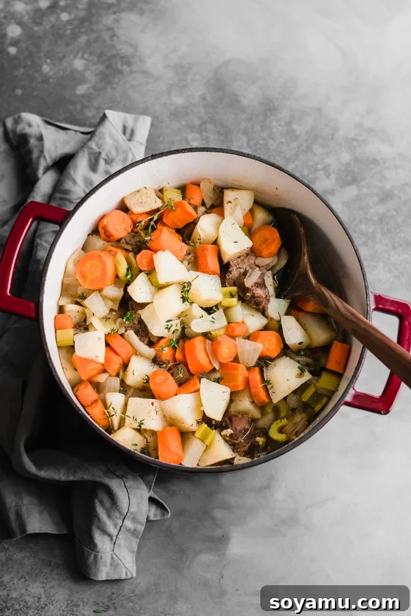 Irish stew simmering in a Dutch oven inside the oven, about an hour into cooking.