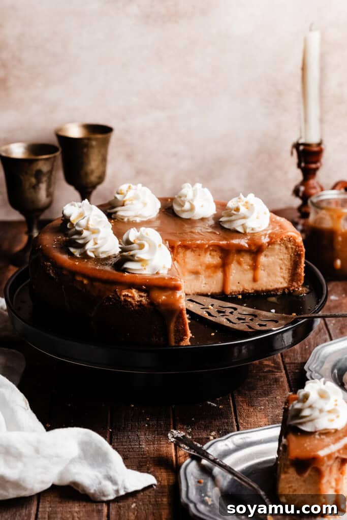 Whimsical Butterbrew Cheesecake 8 The fully baked and sliced Butterbeer Cheesecake, showcasing its smooth, creamy texture and distinct layers, presented beautifully on a cake stand.