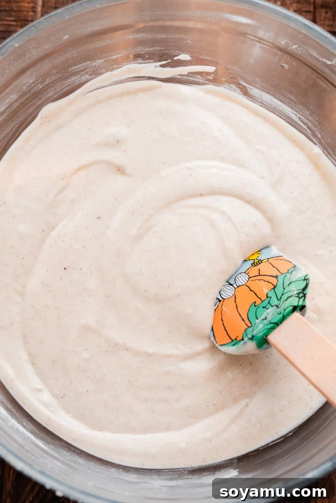 Sticky Apple Caramel Cake 6 A bowl of smooth, golden cake batter, perfectly mixed and ready to be poured.
