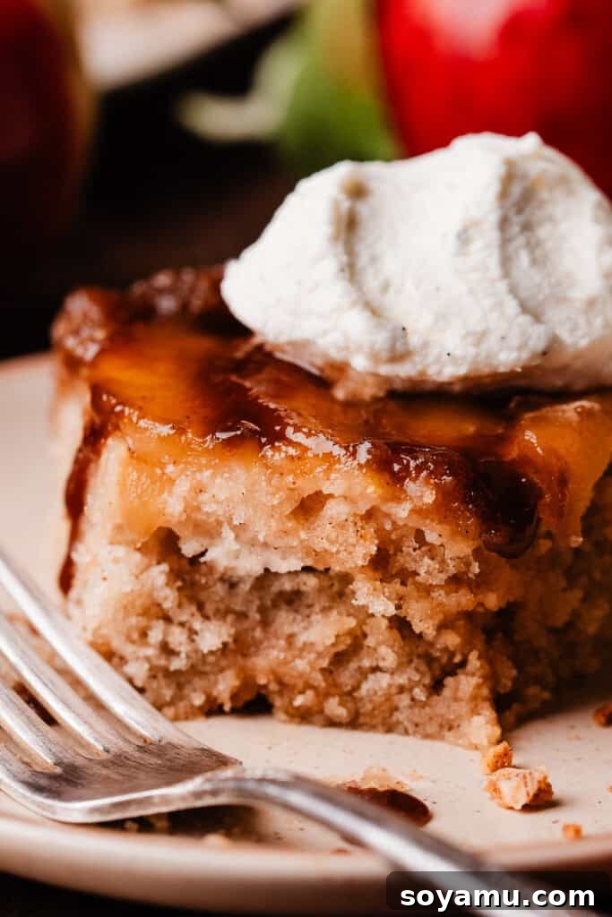 Sticky Apple Caramel Cake 10 A close-up of a delicious slice of caramel apple upside down cake, with a few bites missing, showing its irresistible nature.