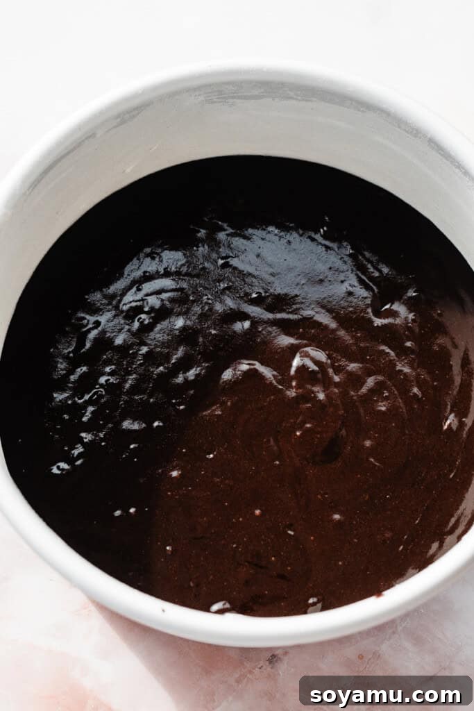 Ultimate Eggless Chocolate Fudge Cake 6 A cake pan filled with chocolate cake batter, ready to be placed in the oven.