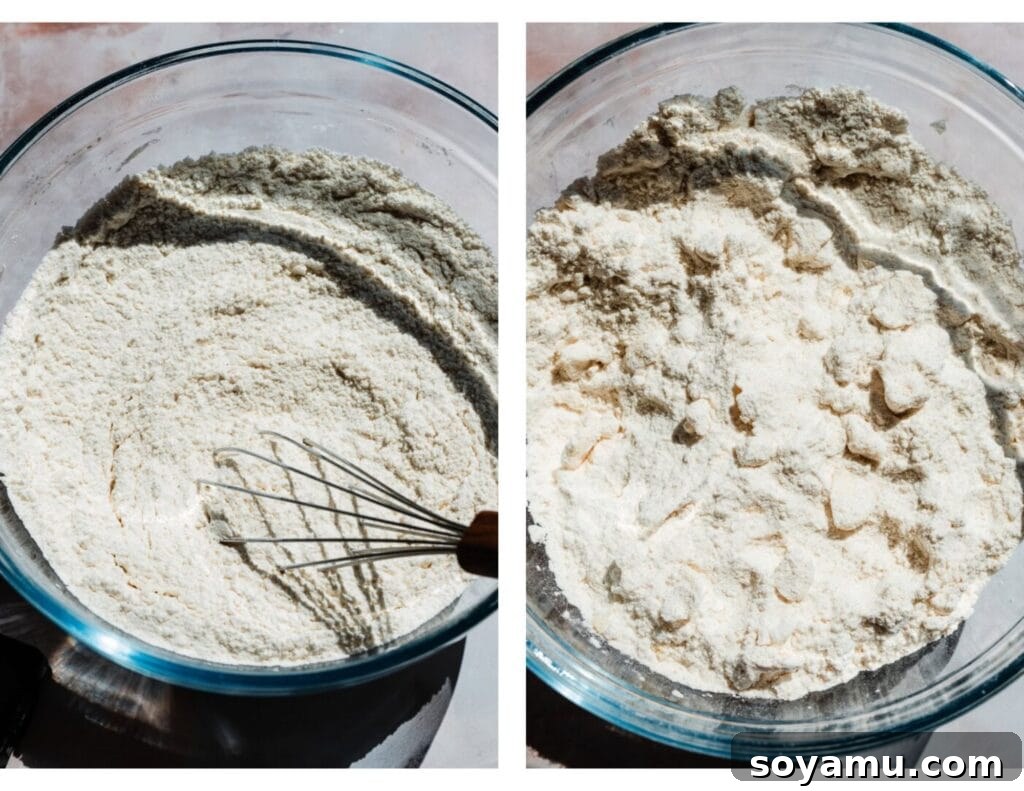 Double Blueberry Scones 4 A large mixing bowl containing a flour mixture with cold, cubed butter that has been cut into pea-sized pieces, illustrating the ideal crumbly consistency before wet ingredients are added. This crucial step ensures flaky scones.