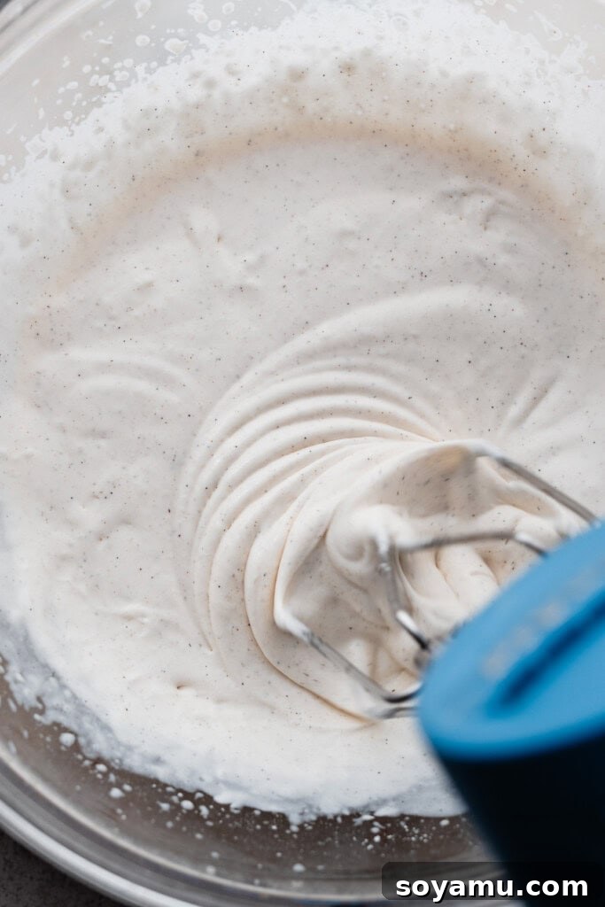 Whip Up Perfect Homemade Cream 5 The process of whipping cream with an electric mixer, showing the texture beginning to form.