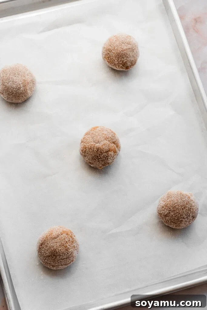 Nutty Brown Butter Thick Chewy Sugar Cookies 8 A baking pan filled with unbaked cookie dough balls, spaced out for even baking.