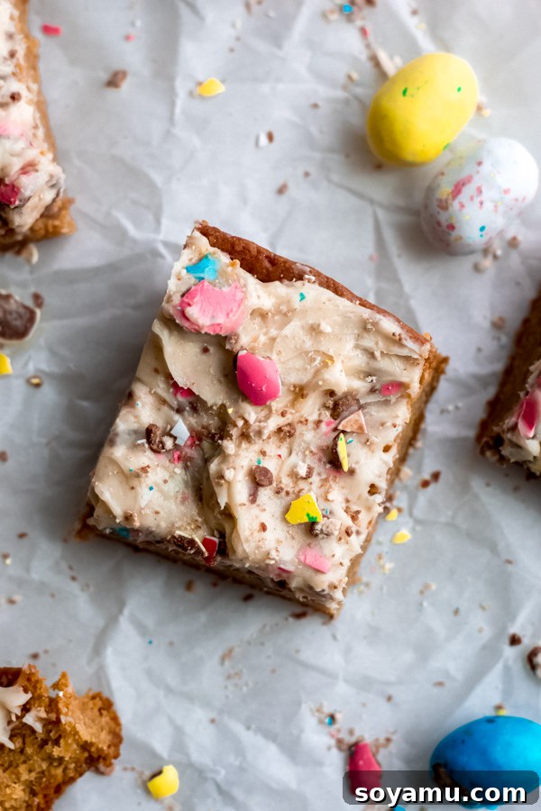 Close-Up Perfection: The Ultimate Easter Egg Blondie Experience A delectable close-up of a single Easter egg blondie, showcasing its rich texture, gooey center, and colorful frosting with candy pieces.