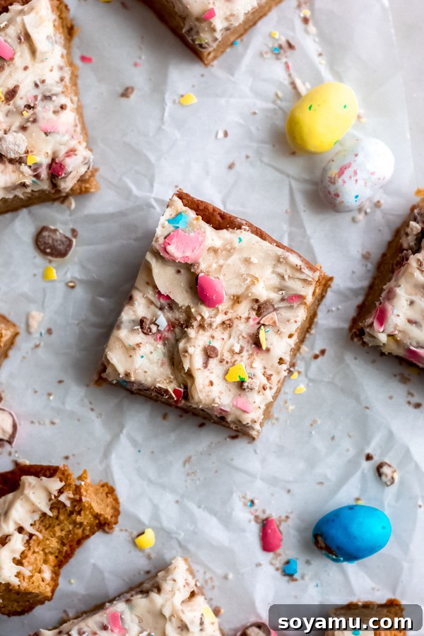 Gooey and Fluffy Easter Egg Blondies - A Delicious Hybrid of Blondie and Sheet Cake A close-up of freshly baked Easter egg blondies, highlighting their golden-brown edges and soft interior, ready for frosting.