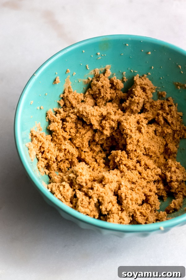 Creaming Butter and Brown Sugar: The Foundation of Caramel-Rich Blondies Softened butter and rich brown sugar being creamed together in a mixing bowl, forming a light and fluffy mixture for blondies.