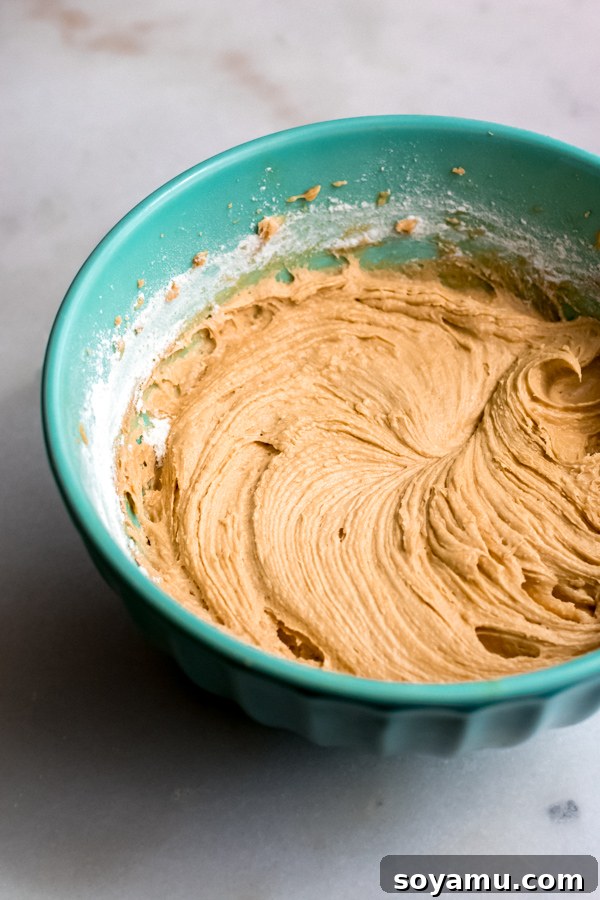 Perfect Blondie Batter: Rich, Thick, and Dangerously Delicious Thick, golden blondie batter mixing in a bowl, showcasing its rich texture before being spread into a baking pan.