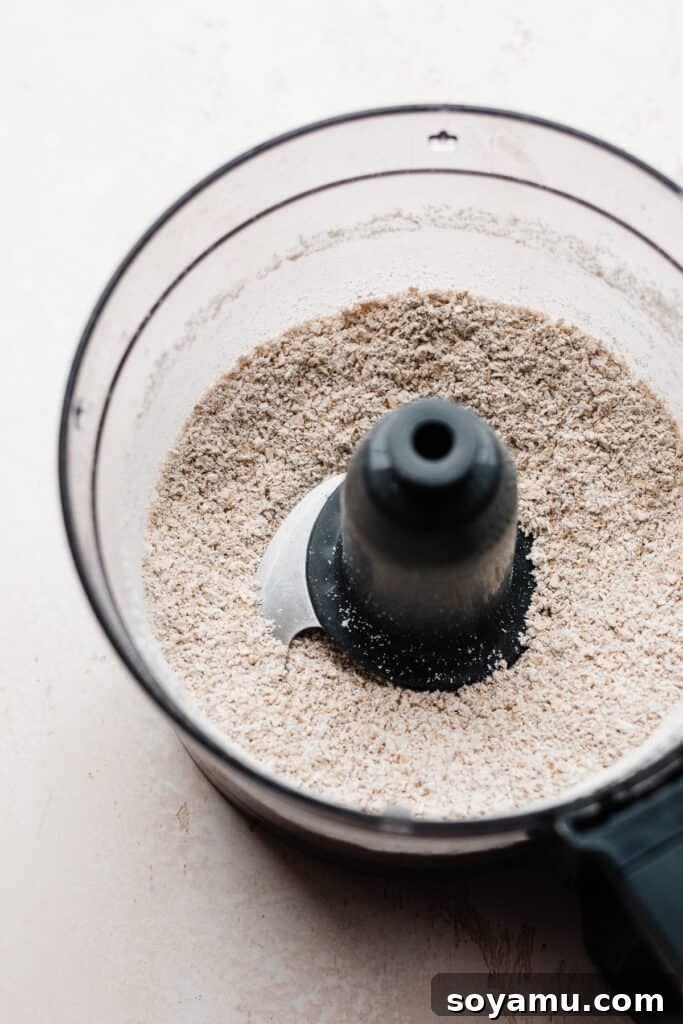 Wholesome Banana Chocolate Oat Muffins 4 Close-up of freshly made oat flour in a food processor, ready for baking.