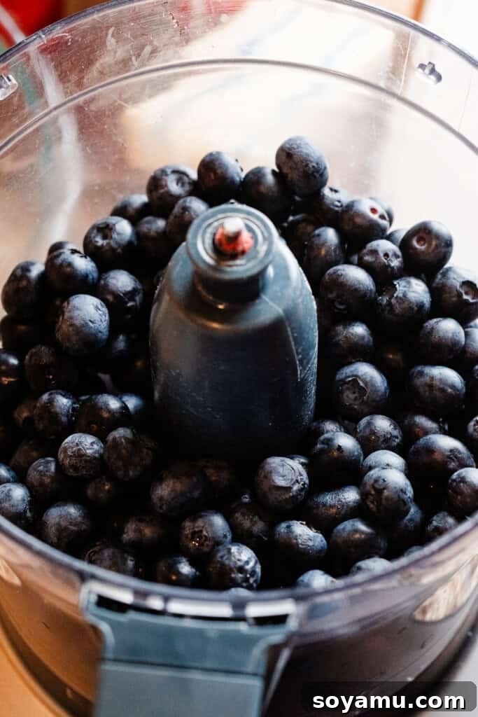Blueberry Bliss Cake 4 Fresh blueberries in a food processor, ready to be blended.