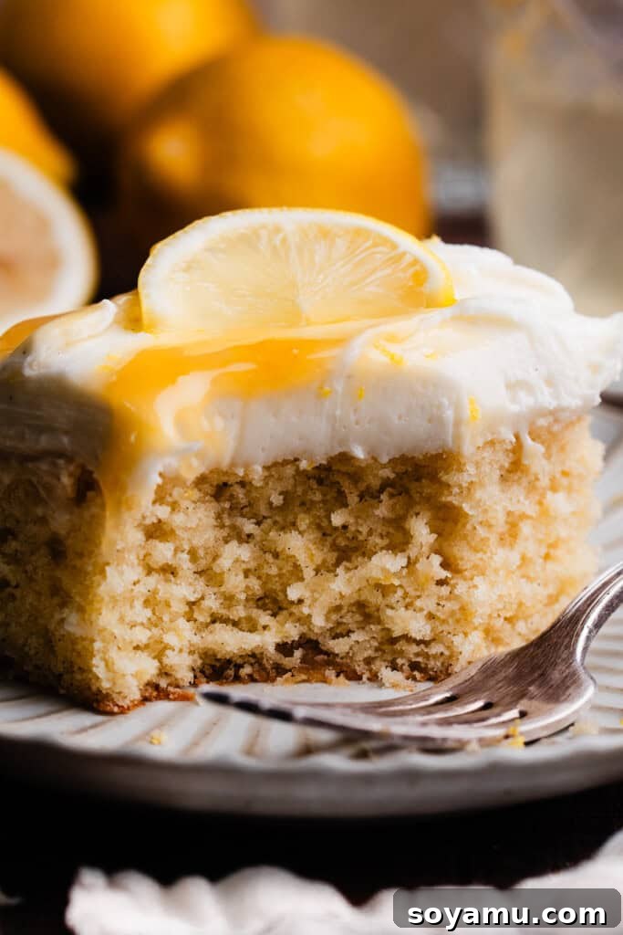 Velvet Lemon Mascarpone Cake 11 A beautifully sliced piece of lemon curd cake on a dessert plate, ready to be enjoyed.
