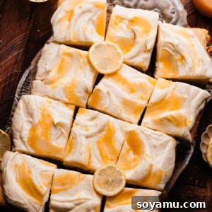 The sliced lemon curd cake on a vintage tray, topped with swirls of lemon curd.