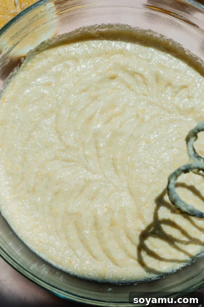 Velvet Lemon Mascarpone Cake 5 Mixing the cake batter in a large bowl, showing the creamy texture.