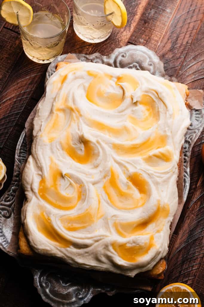 Velvet Lemon Mascarpone Cake 10 A beautifully decorated lemon curd cake with lemon mascarpone frosting, topped with swirls of golden lemon curd and fresh lemon slices.