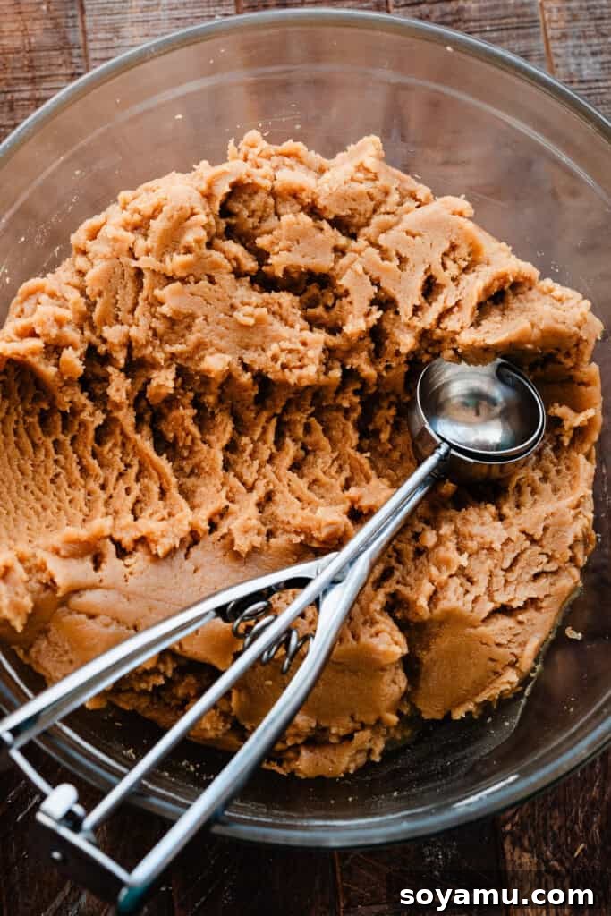 Chill-Free Peanut Butter Cookies 5 A large mixing bowl filled with rich, ready-to-bake peanut butter cookie dough, showcasing its thick and slightly textured consistency.