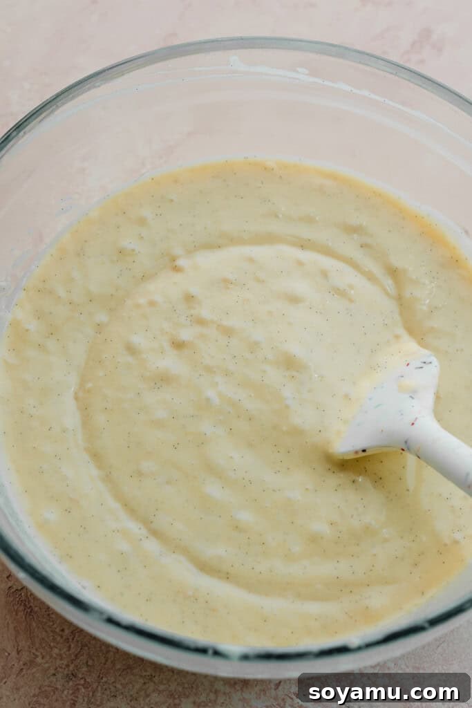 A bowl containing the semi-thin, smooth cupcake batter, perfectly mixed and ready for baking.
