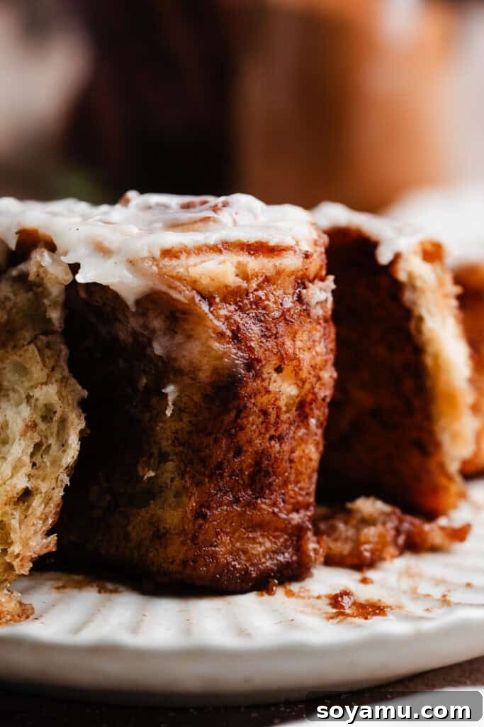 A close-up shot focusing on the gooey, soft center of a freshly baked cinnamon roll, showcasing its incredible texture.