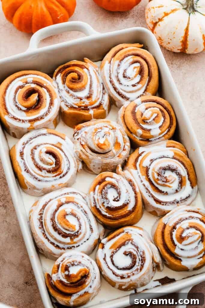 The risen rolls in the pan, with heavy cream poured over them just before baking.