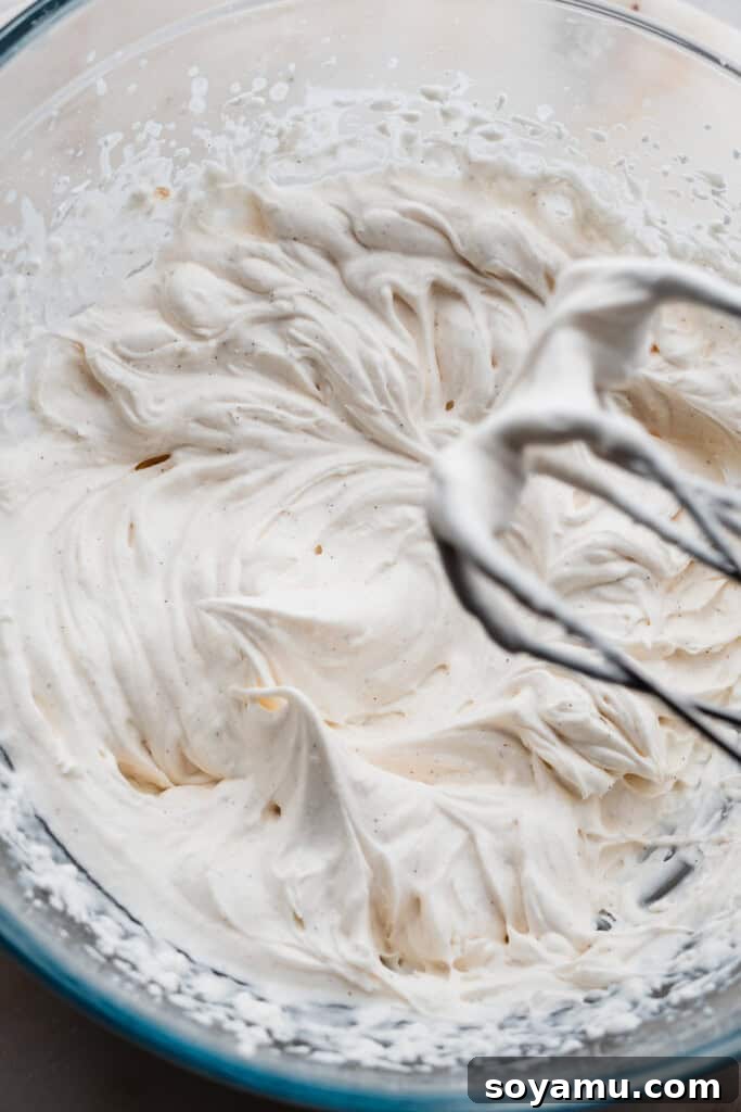 Perfectly Simple Pumpkin Pie Bars 9 A bowl of freshly made whipped cream, whipped to firm, stiff peaks, ready for topping.