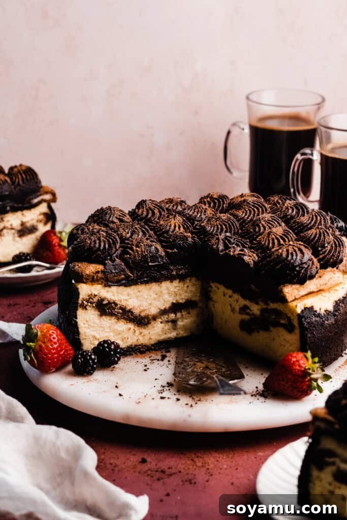 Simple Two Ingredient Oreo Dessert Crust 9 A stunning Tiramisu Cheesecake with a visible dark Oreo cookie crust, beautifully garnished with cocoa powder and delicate coffee beans.