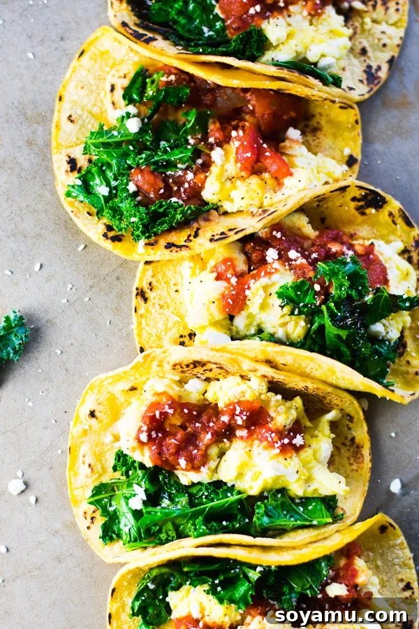 Quick Breakfast Tacos with scrambled eggs, sautéed kale, fire-roasted tomato salsa, corn tortillas, and cheese – a delicious, easy, and gluten-free breakfast recipe.