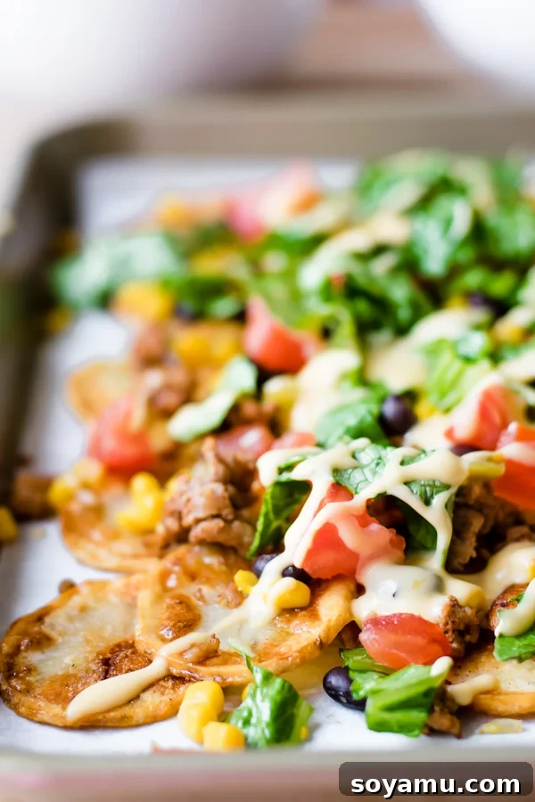 One-Pan Nacho Feast 7 Close up of a loaded sheet pan nachos serving