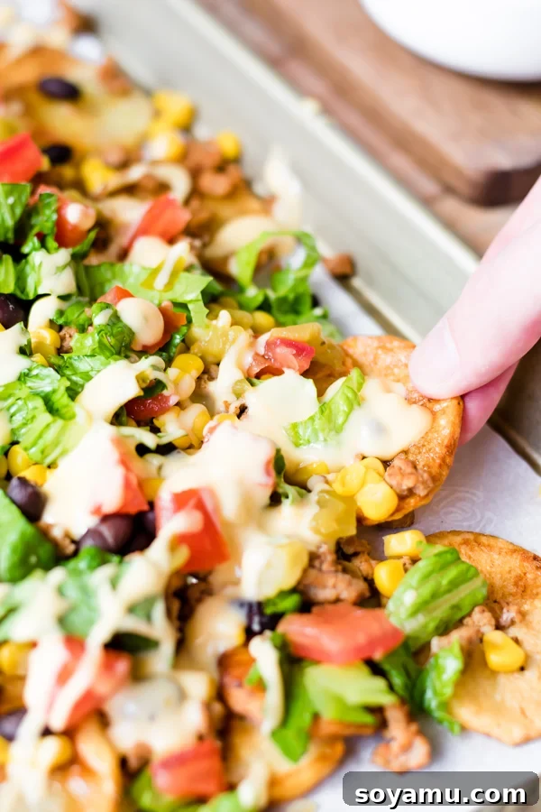One-Pan Nacho Feast 8 A large serving of loaded sheet pan nachos ready to eat