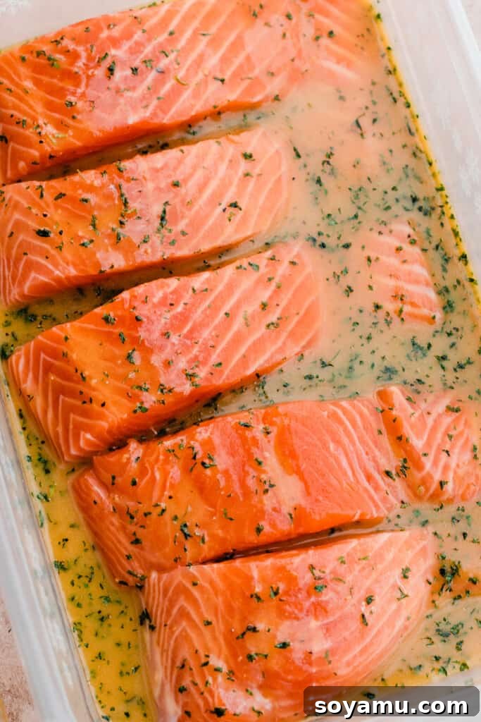Sheet Pan Caramelized Maple Salmon with Crispy Potatoes 5 Salmon filets in a tupperware in the maple marinade.