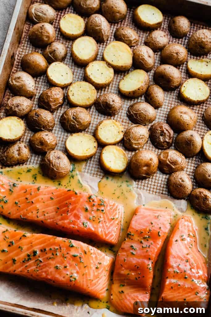 Sheet Pan Caramelized Maple Salmon with Crispy Potatoes 6 The sheet pan with the halfway cooked potatoes & the raw, marinated salmon.