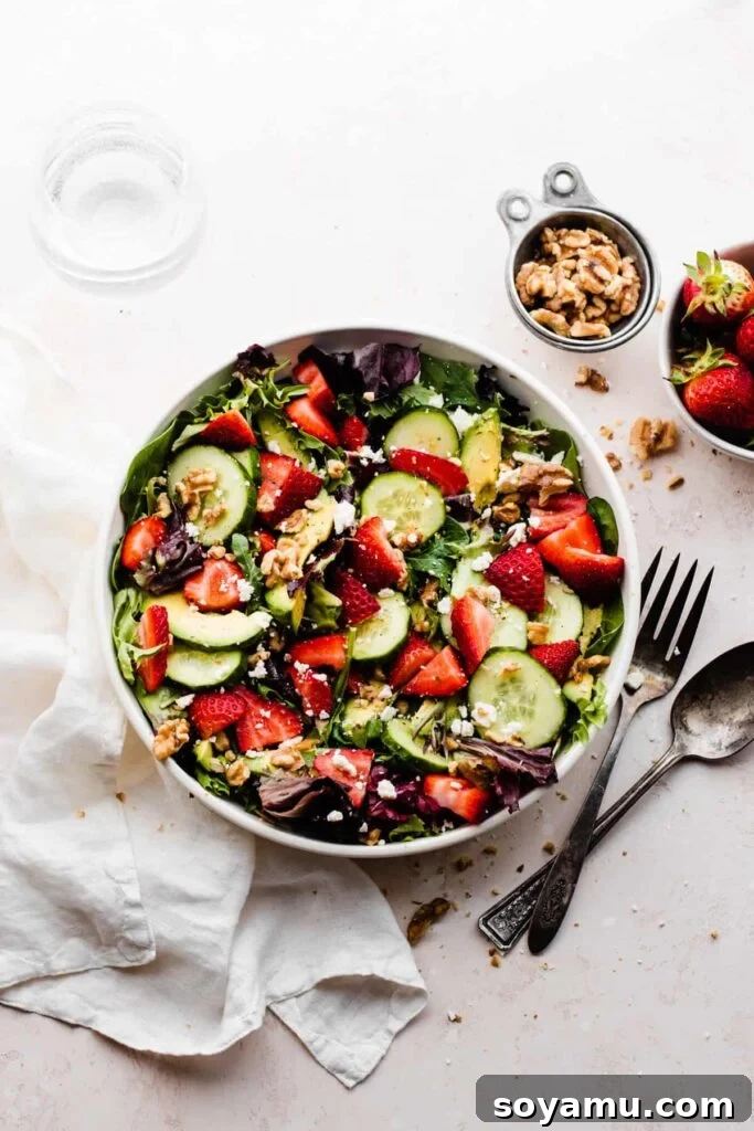 Vibrant Strawberry Cucumber Salad with Goat Cheese and Toasted Walnuts 2 A bowl of strawberry salad with cucumbers, walnuts, feta, and fresh greens.