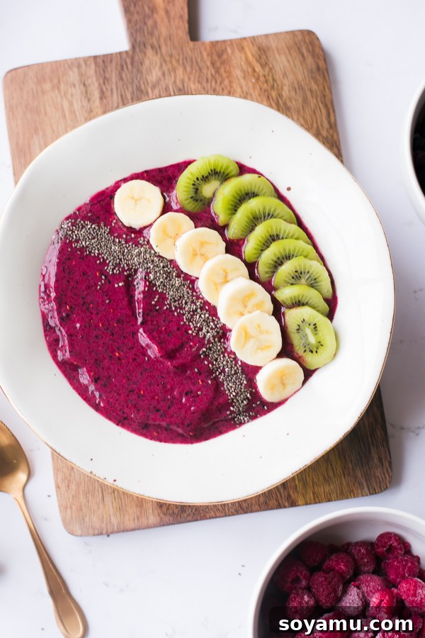 Hands holding a 5-Minute Smoothie Bowl topped with colorful fruit