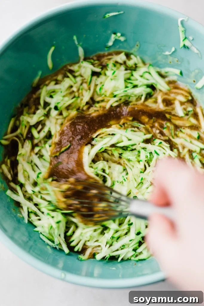 Zucchini being whisked into the bowl.