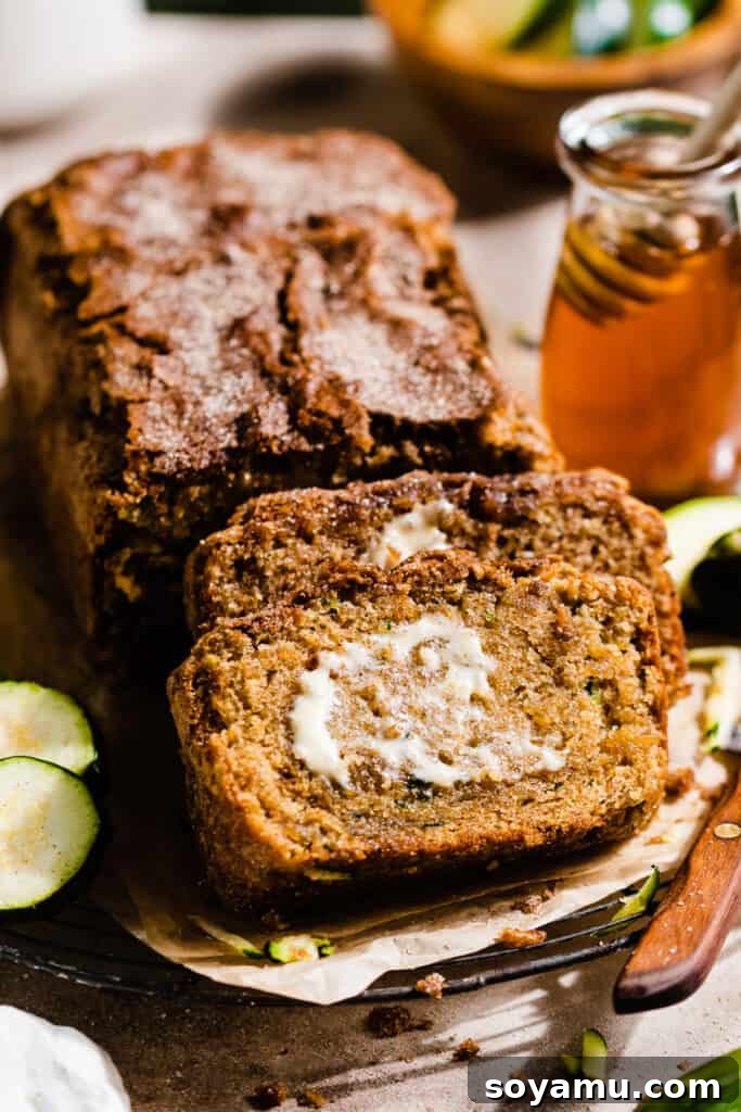 Slices of the zucchini bread propped up against the loaf.