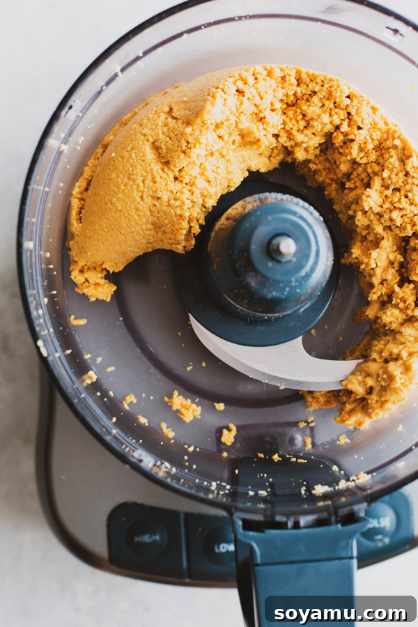 Freshly Made Peanut Butter 5 Peanut mixture transitioning to a thicker paste
