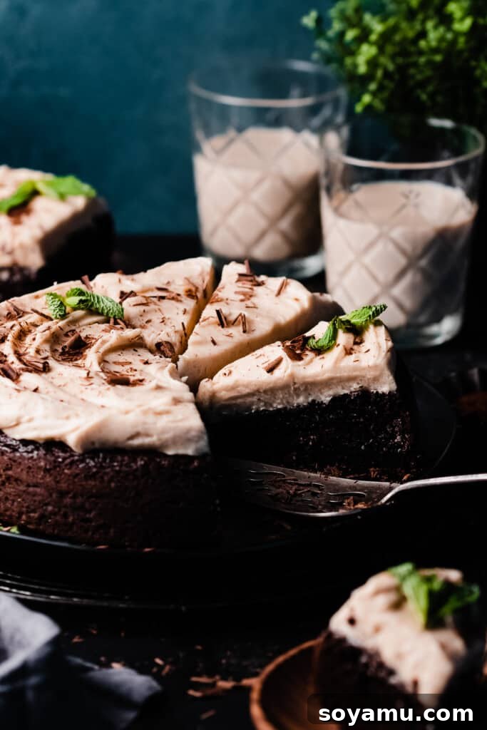 Decadent Baileys Chocolate Cake with Silky Cream Cheese Frosting 11 The sliced baileys chocolate cake on a cake plate.