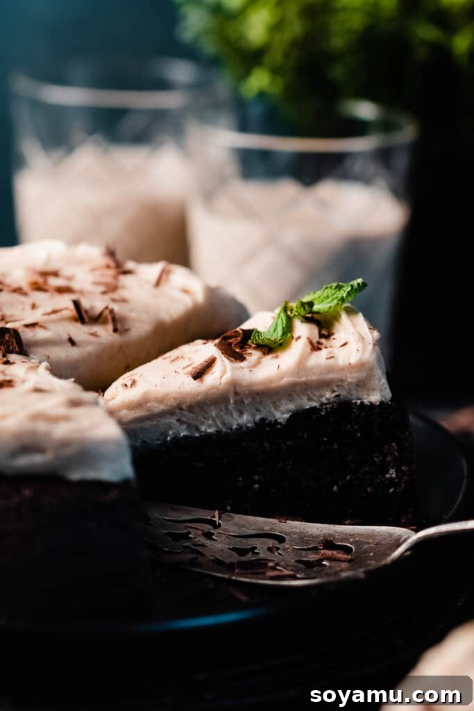Decadent Baileys Chocolate Cake with Silky Cream Cheese Frosting 8 A close-up of a slice of the chocolate snack cake.