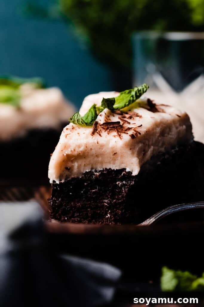 Decadent Baileys Chocolate Cake with Silky Cream Cheese Frosting 10 A close-up on a slice of the cake with a bite missing.