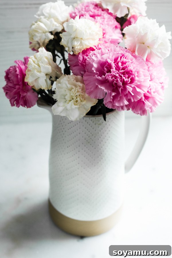 10 Easy Ways to Improve Your Food Photography - 10 Quick + easy tips to take your food photography to the next level! #foodphotography #foodphotos #bloggers #bloggingresources #blogresources #bloggerresources #photographyresources #photographytips | bluebowlrecipes.com A vase of fresh flowers, artfully arranged and lit by corner light, demonstrating how this angle creates balanced illumination.