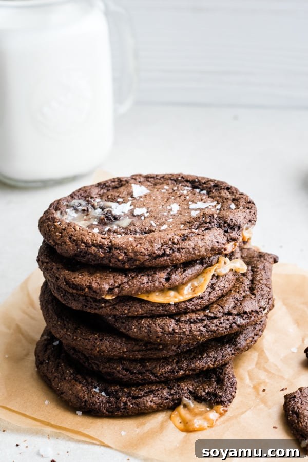 A pair of delightful caramel-stuffed chocolate cookies, perfect for sharing (or not!). Two Caramel-Stuffed Chocolate Cookies showing their delicious texture and filling.