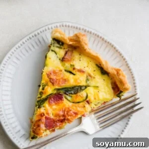 The Ultimate Breakfast Quiche 3 A slice of breakfast quiche on a plate.