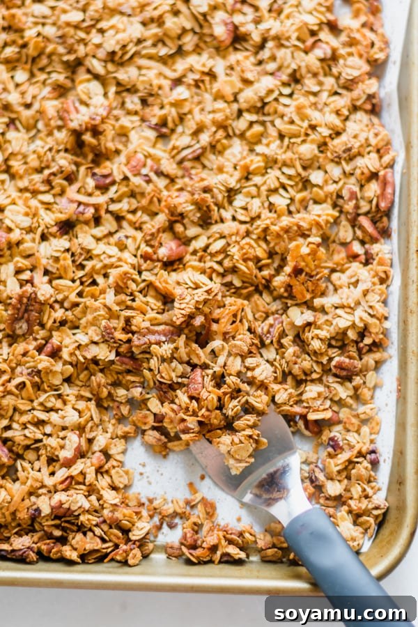 Peach Crisp Yogurt Parfaits 4 Close-up of golden brown homemade maple granola on a baking sheet, ready for consumption.