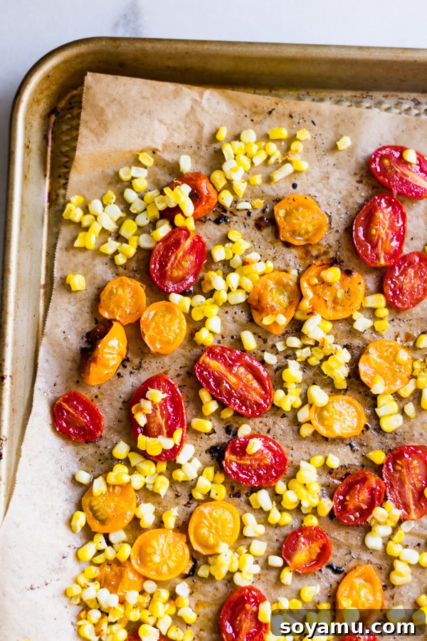 Tray of roasted cherry tomatoes and corn kernels, ready for the flatbread pizza.