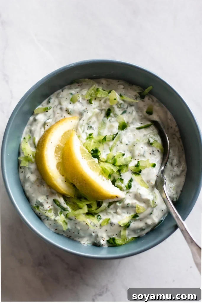 Savory Chicken Gyro Bowls with Artisan Tzatziki 4 A close-up of a bowl filled with creamy homemade tzatziki sauce, garnished with fresh dill.