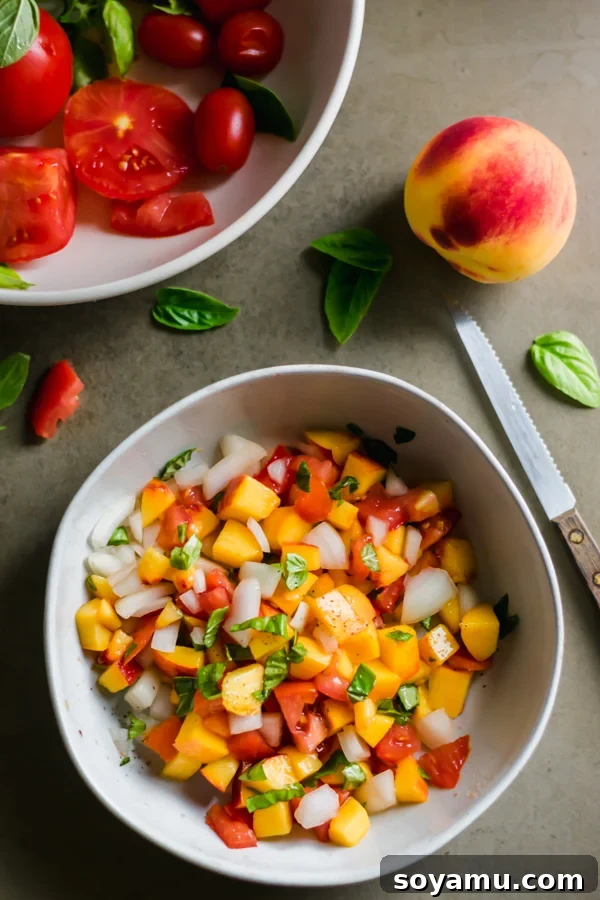 Close up view of the colorful peach salsa in a white bowl.