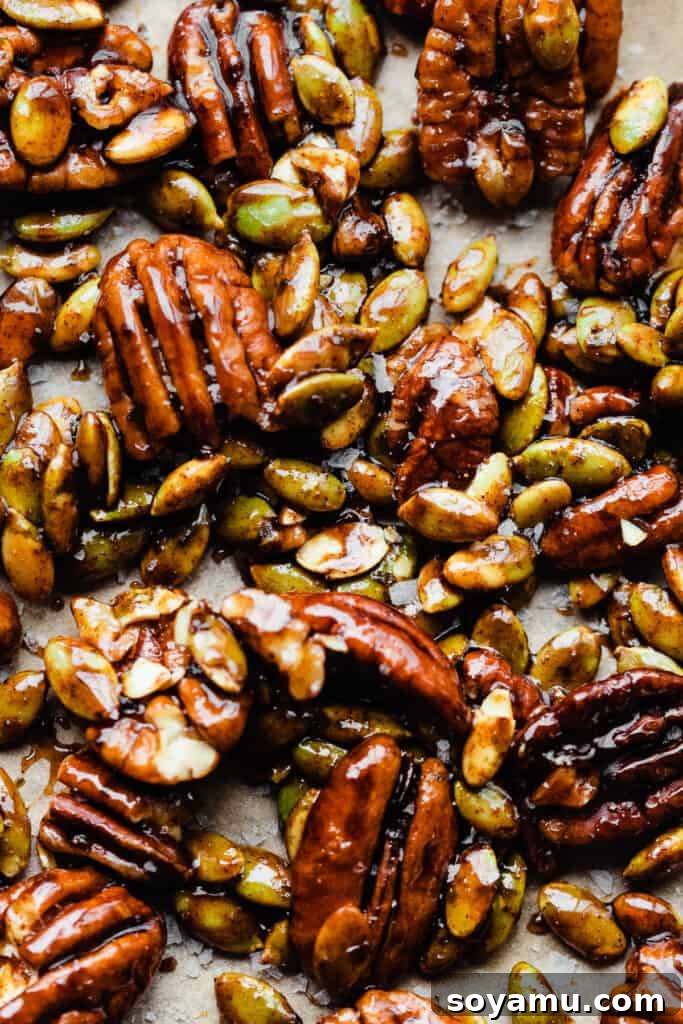 Pillowy Pumpkin Spice Pancakes 6 A close-up view of glistening candied pecans and pepitas cooling on a baking sheet.
