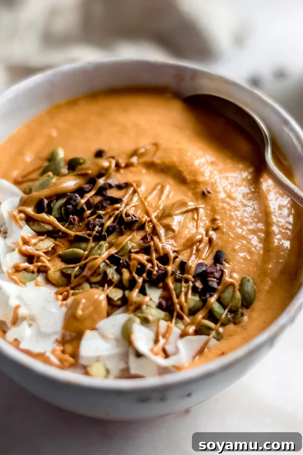 Fall Glow Smoothie Bowl - A delicious, creamy smoothie made with real food ingredients and lots of fall flavor. All you need for this filling breakfast is 6 ingredients and 10 minutes! #bluebowlrecipes #fall #smoothie #smoothiebowl #sweetpotato #dairyfree #vegan #glutenfree #breakfast #healthybreakfast | bluebowlrecipes.com Another enticing view of the Fall Glow Smoothie Bowl, highlighting its rich color and generous toppings.