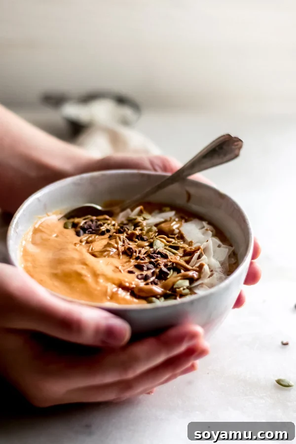 Fall Glow Smoothie Bowl - A delicious, creamy smoothie made with real food ingredients and lots of fall flavor. All you need for this filling breakfast is 6 ingredients and 10 minutes! #bluebowlrecipes #fall #smoothie #smoothiebowl #sweetpotato #dairyfree #vegan #glutenfree #breakfast #healthybreakfast | bluebowlrecipes.com A final picturesque shot of the Fall Glow Smoothie Bowl, emphasizing its comforting autumn feel.