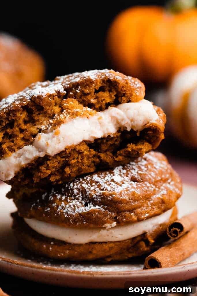 Brown Butter Pumpkin Whoopie Delights 11 A close-up of half of a pumpkin whoopie pie, revealing its fluffy, moist interior and delicious frosting layer.