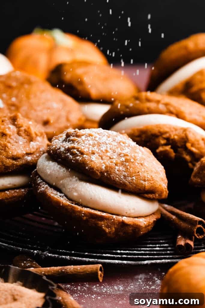 Brown Butter Pumpkin Whoopie Delights 9 A close-up of a whoopie pie being delicately dusted with powdered sugar, adding a final touch of elegance.